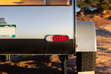 Explore outdoors! Rear of an RV rental camper with Colorado plate, bright LED lights, and rugged tire, ready for adventure.