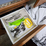 Compact kitchen organization in an rv rental: a drawer full of cooking utensils, silverware, and a pizza cutter.