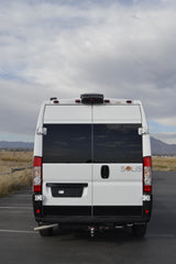 Rear view of a white Solis camper van, perfect for RV rental. Parked outdoors, ready for your road trip.