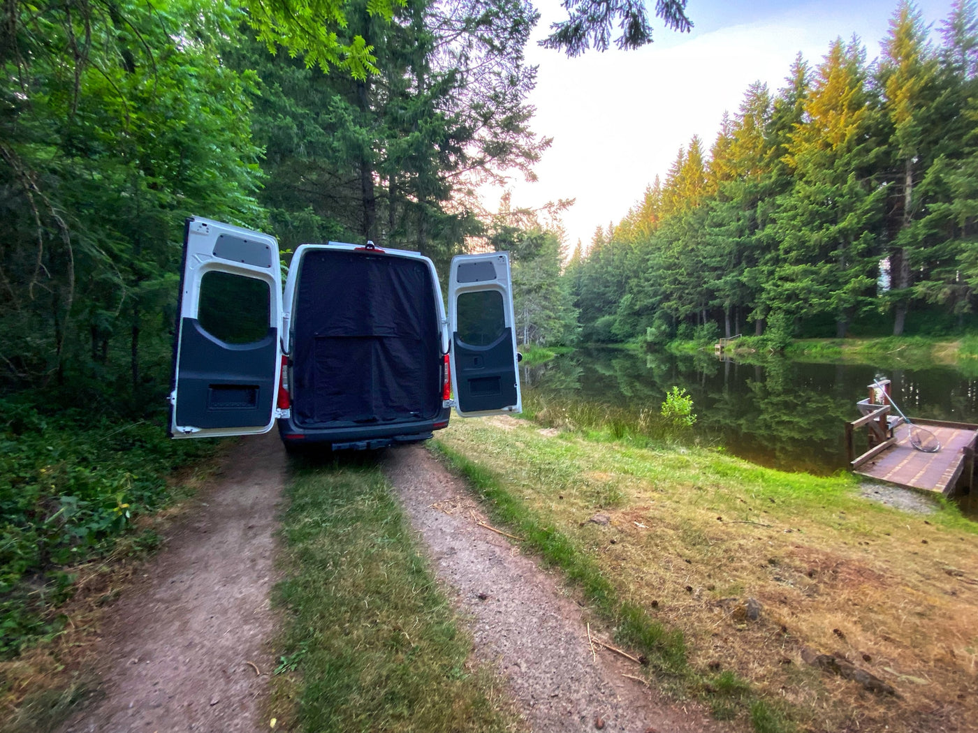  parked on a dirt forest path at sunset — photo 3