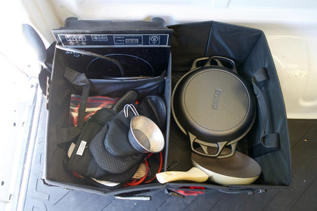 Portable RV rental kitchen setup: induction cooktop, cast iron pan, and cooking essentials for camping.