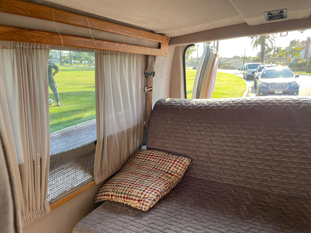  palm-lined street with parked cars. Ready for travel!|White Ford E-Series conversion van — photo 6