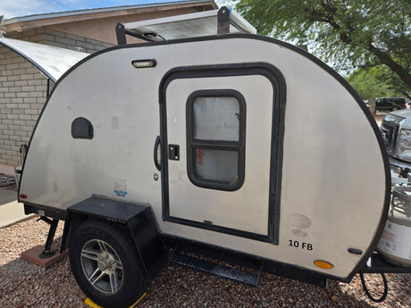 This Braxton Creek teardrop camper, with solar panel and propane tank, is perfect for your next RV rental adventure.