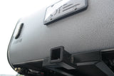 Textured grey Teardrop travel trailer rear, with license plate frame and hitch receiver for RV rental adventures.