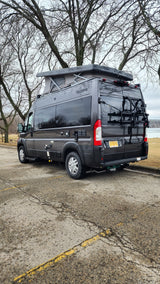 This dark gray Scope pop-top camper van with bike rack makes a great rv rental for scenic trips by the water.