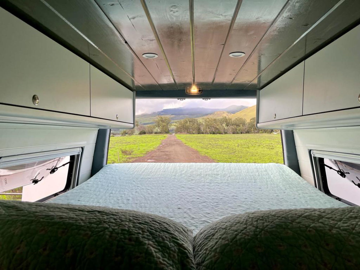  functional mobile living space.|RV rental interior: A cozy dining area with a table and black seats — photo 8