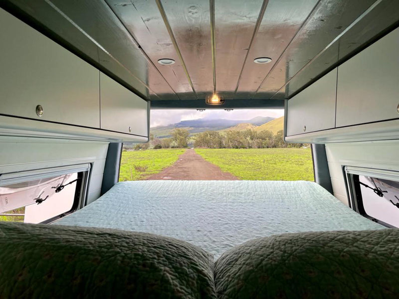  functional mobile living space.|RV rental interior: A cozy dining area with a table and black seats — photo 8