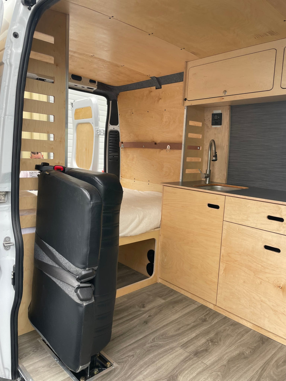  and ample storage for comfortable van life.|RV rental van interior: stacked wooden bunk beds — photo 6