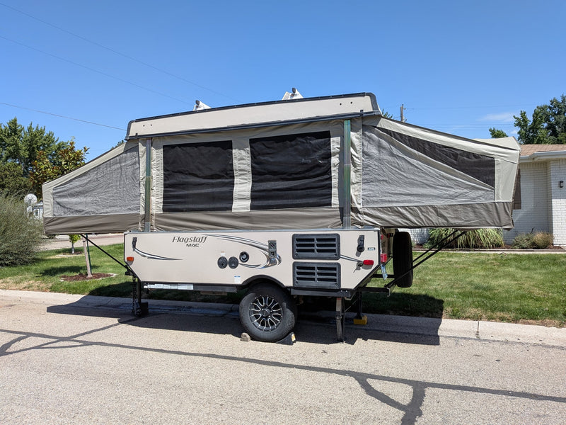  parked on a sunny residential street.|A fully expanded pop-up camper — photo 5