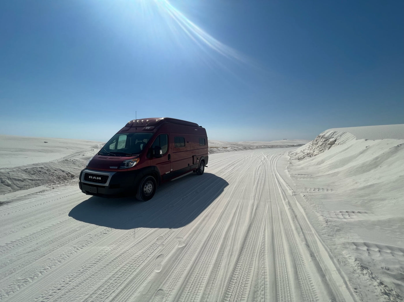  blanket in winter scene.|A red RV rental van drives on a snowy road through a pine forest — photo 2