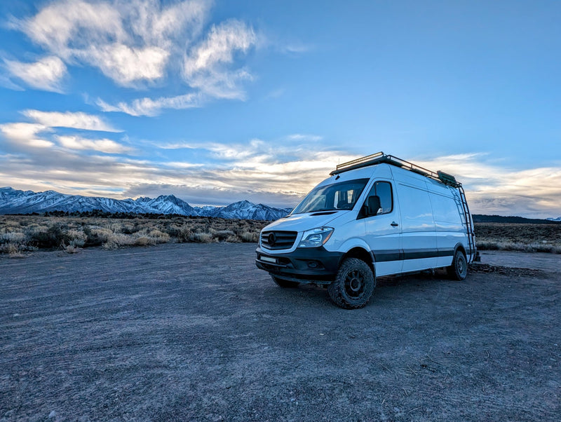  and adjustable pilot seats in the cabin.|A shaggy black dog with warm eyes & a dark dog with a bandana relax on a wood floor. Perfect comfort for your RV rental journey.|Smiling man gives a thumbs up inside a cozy RV rental — photo 16