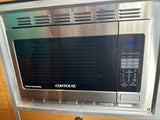 A stainless steel CONTOURE Power Convection microwave oven and air fryer built into an RV rental, with digital controls.