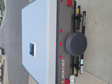 Rear view of an RV rental, a Flagstaff travel trailer with a spare tire and Colorado license plate.