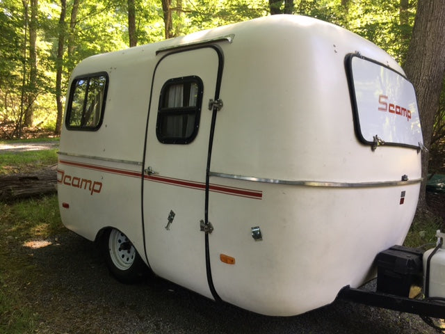 Charming Scamp travel trailer in a wooded setting, ideal for an RV rental adventure and a cozy camping experience. — photo 4