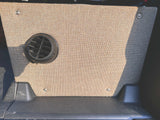 RV rental camper van interior. Beige woven fabric panel with black circular vent & durable floor.