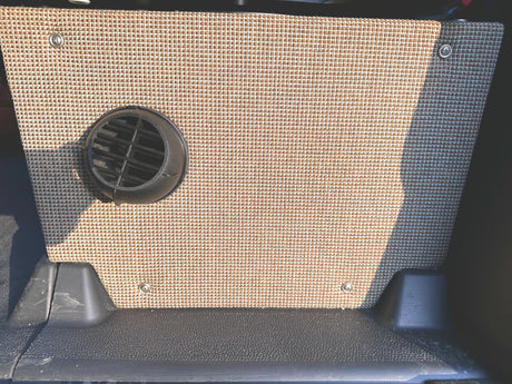 RV rental camper van interior. Beige woven fabric panel with black circular vent & durable floor.