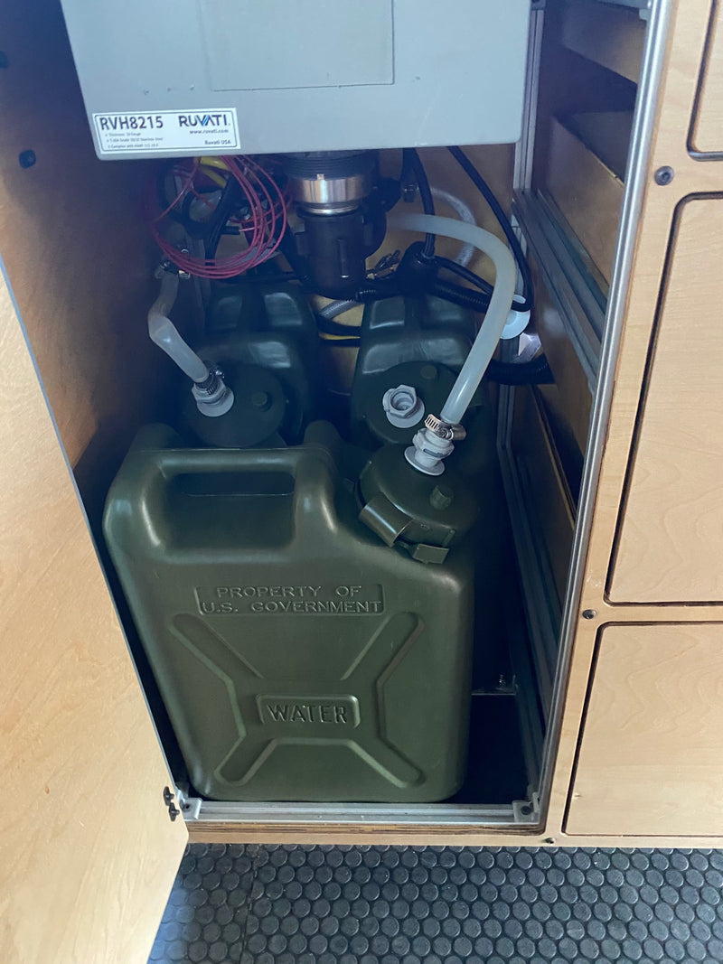 RV rental's compact water system: Two "U.S. GOVERNMENT" jerrycans supply water via hoses to a Ruvati pump for mobile plumbing. — photo 20