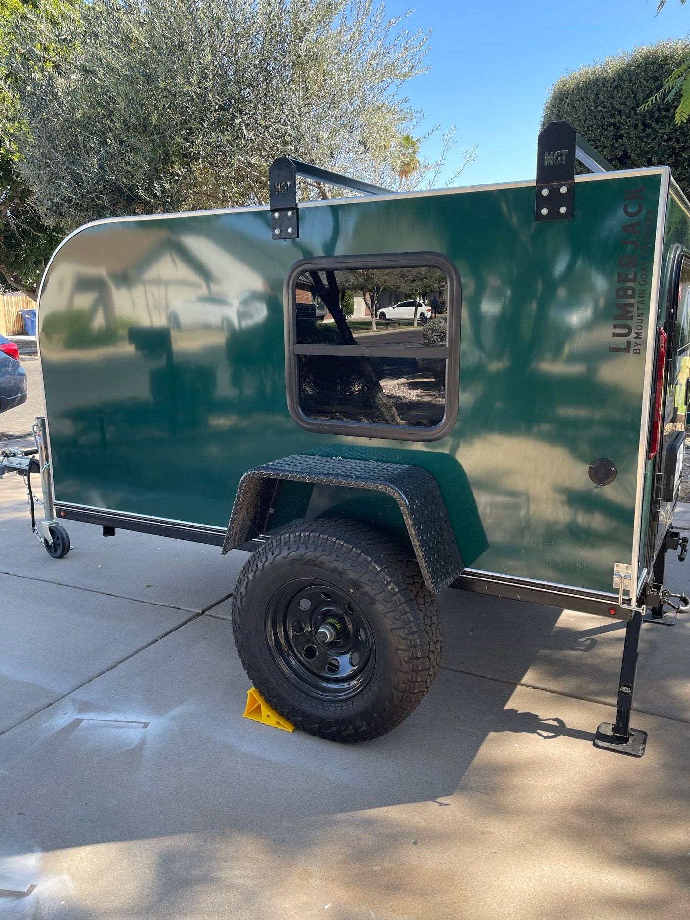 Rugged, dark green 'Lumberjack' teardrop RV rental, perfect for off-road camping & travel adventures.