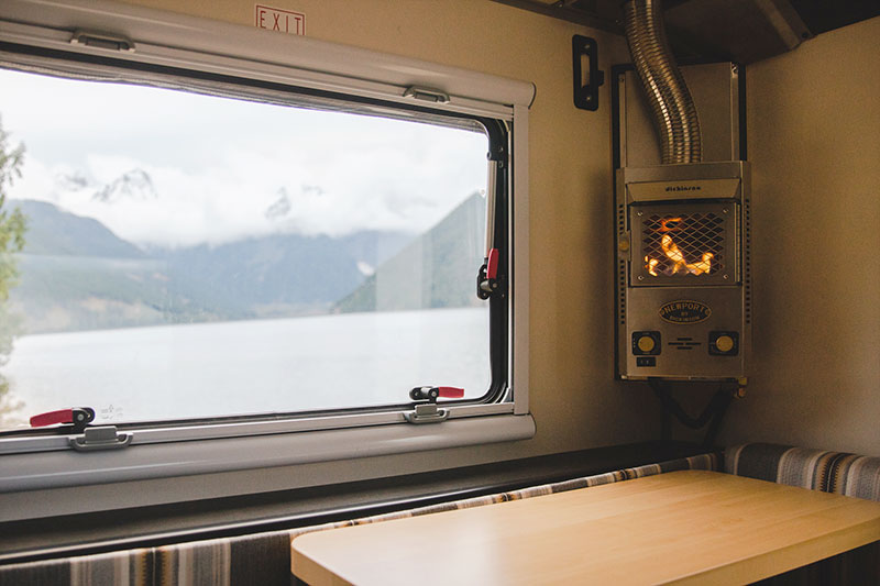  and storage. Ideal for adventurers.|Inside a modern RV rental: comfortable seating with a table — photo 5