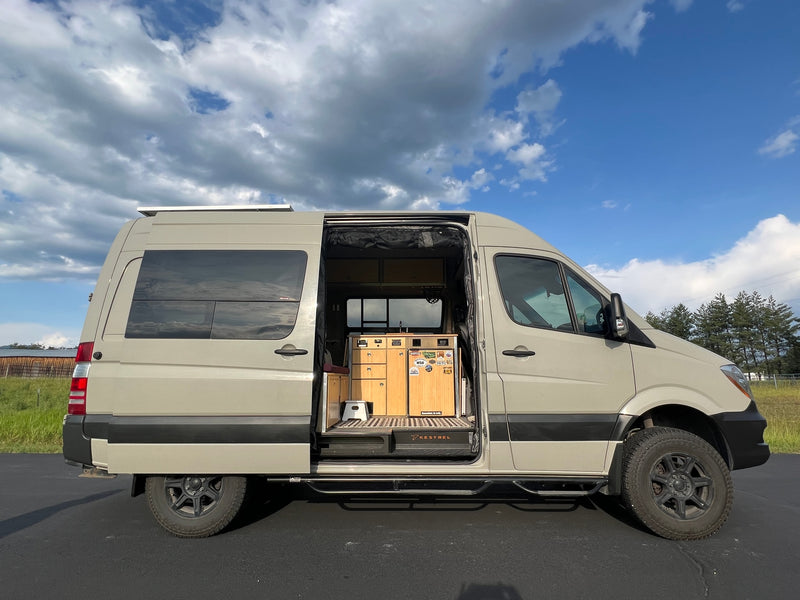 Custom beige camper van, side door open to reveal a tidy interior. Perfect for an RV rental or a unique van life road trip. — photo 7