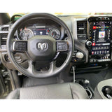 Ram truck interior for rv rental. Shows the steering wheel, digital dashboard, and large vertical infotainment screen.