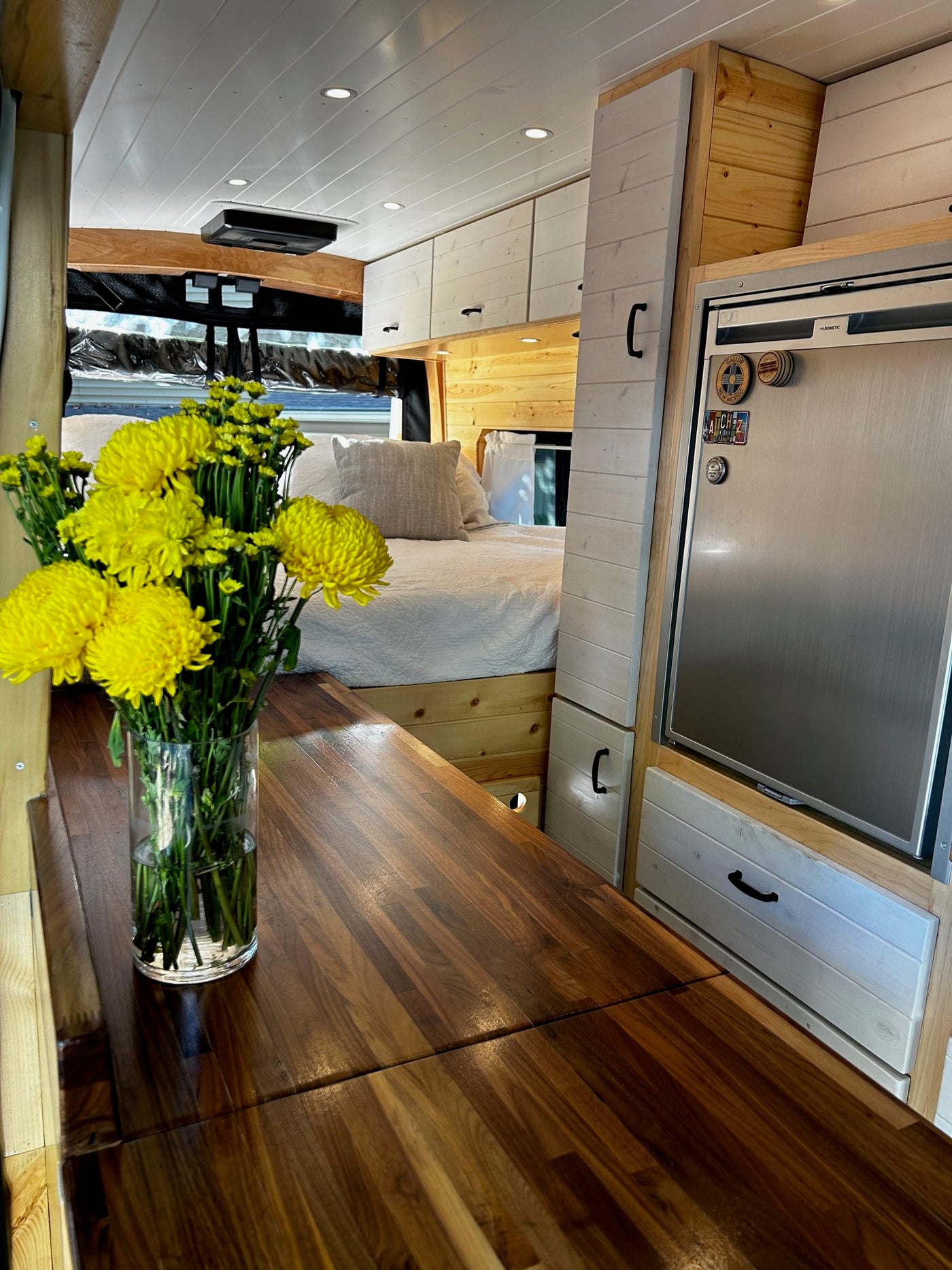  revealing a custom wooden interior. Perfect for RV rental.|RV rental's white roof with a Fiamma F45s awning — photo 8