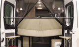 Rear view of an RV rental: open doors reveal a comfortable van bed, mosquito screen, and portable tables.