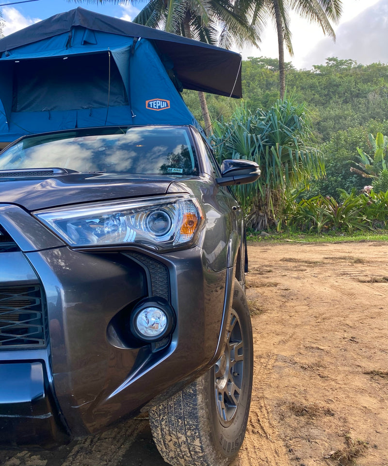 Gray SUV with blue Tepui rooftop tent, a rugged RV rental option for wilderness camping on a dirt road. — photo 18