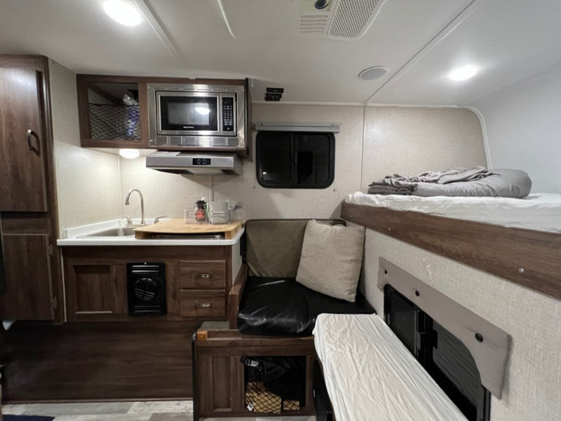  and scenic views.|Cozy RV rental interior with elevated bunk bed — photo 3
