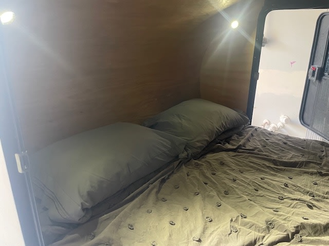  light blue and silver teardrop camper