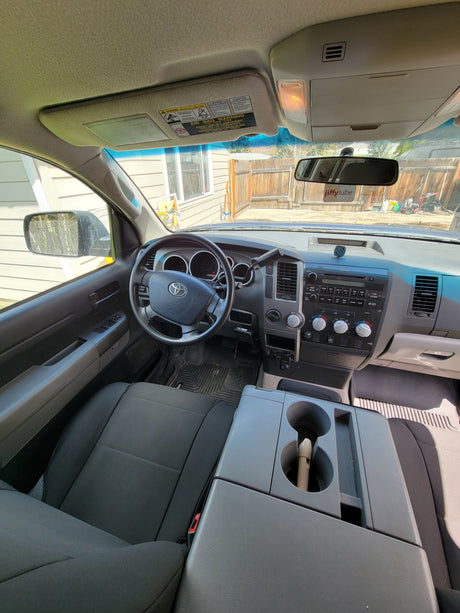 Spacious Toyota truck interior, showing dashboard, steering wheel, and seating. Ideal for an rv rental adventure.