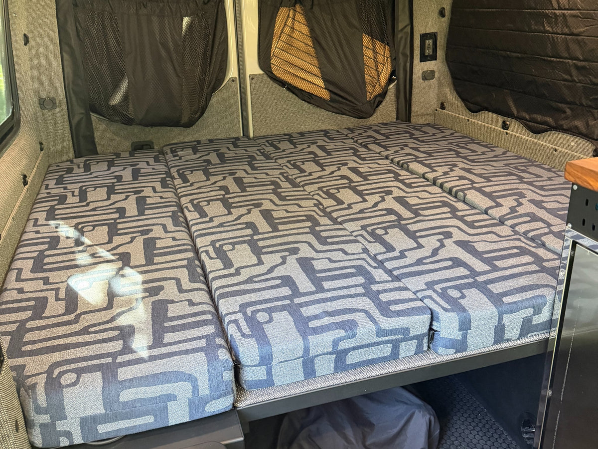 and outdoor living space set up in a sunny pine forest camp.|RV rental cooking setup in a forest: Customized Sprinter van — photo 19