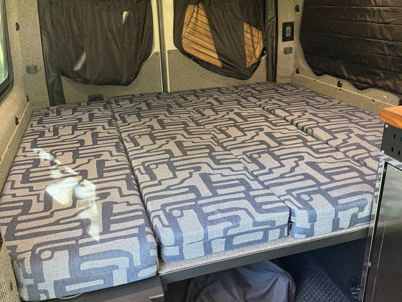  and outdoor living space set up in a sunny pine forest camp.|RV rental cooking setup in a forest: Customized Sprinter van — photo 19