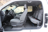 Spacious vehicle interior, perfect for an rv rental. Shows driver's seat, dashboard, rear bench, and durable floor mats.