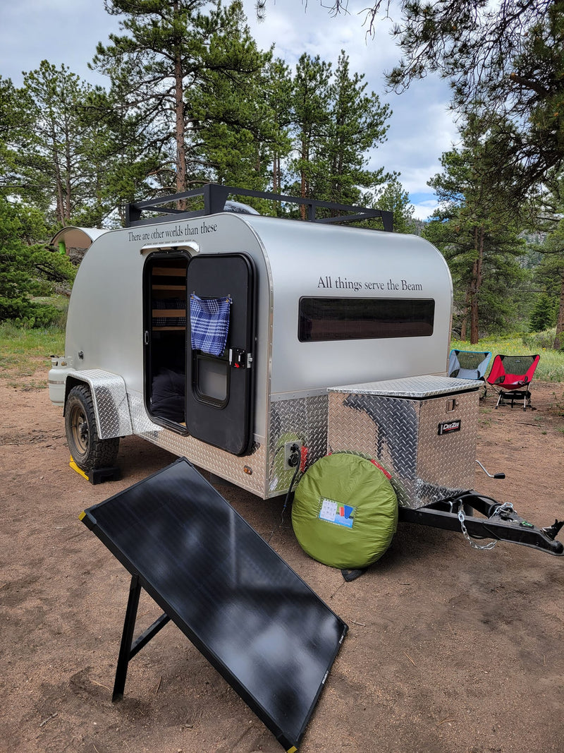 Cozy teardrop rv rental parked at a serene campsite — photo 1