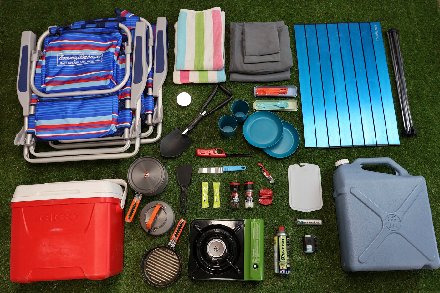 Packed for your RV rental adventure! Complete camping gear: chair, cooler, portable kitchen, table, and water jug.