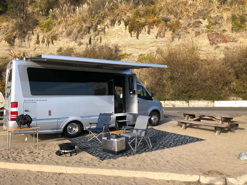 and a vibrant sky.|Coastal RV rental setup with Airstream camper van — photo 9