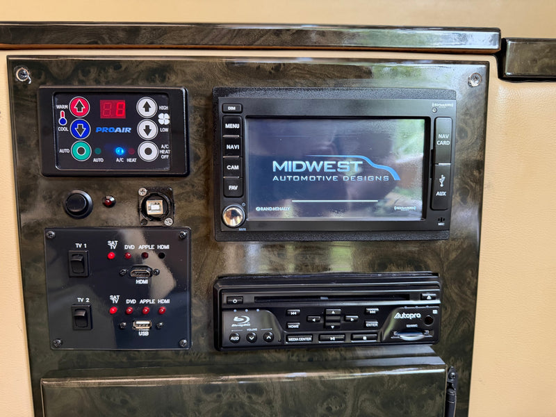 RV rental cockpit view: controls for PROAIR climate, Rand McNally navigation, Autopro Blu-ray player, and multi-media inputs. — photo 16