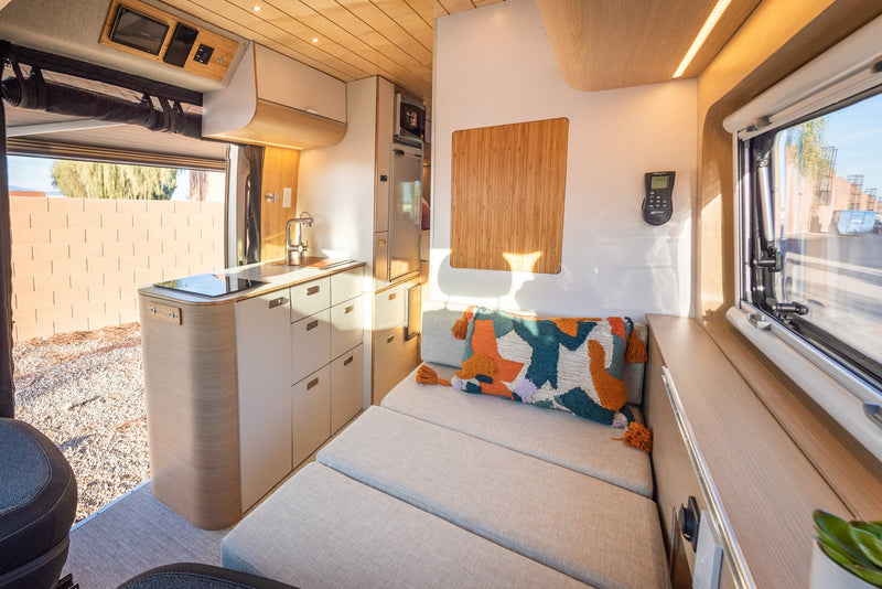  revealing its interior kitchen and fold-out table.|This RV rental features a bright — photo 8