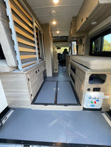 Discover this well-equipped RV rental's interior: convertible bed, storage, utility panel, and easy-clean floors.