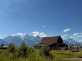 Stunning Grand Teton mountains & historic barn. Perfect RV rental adventure in nature's beauty.