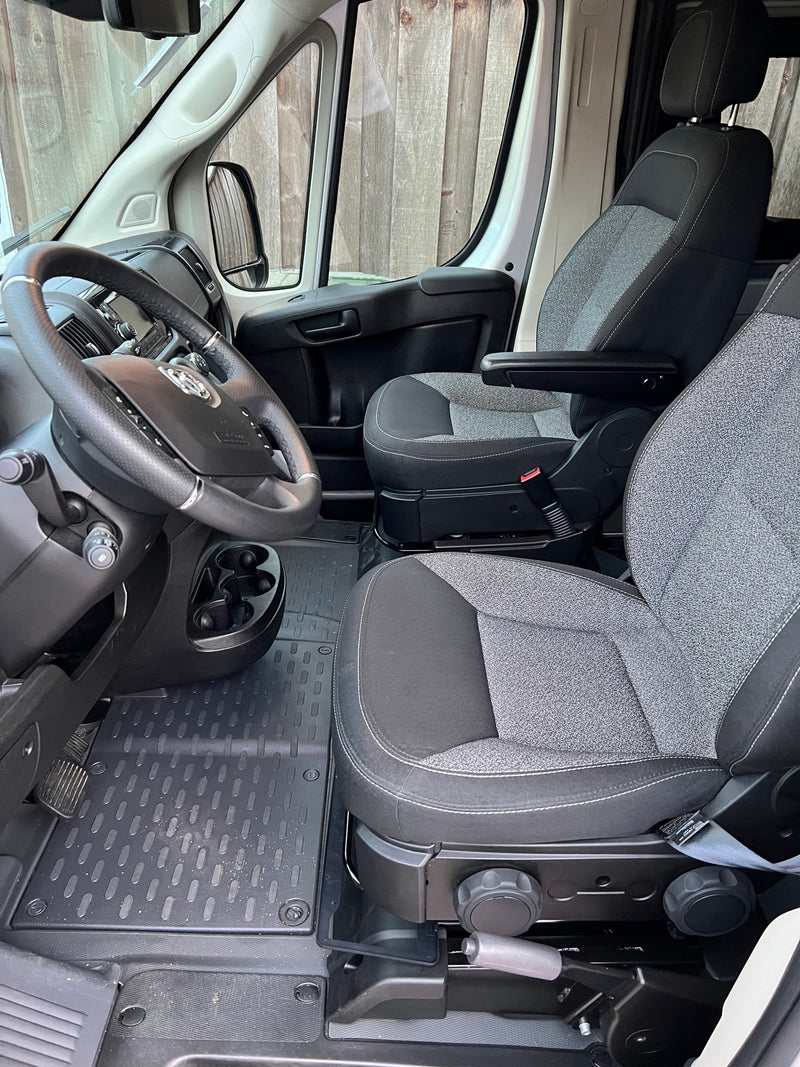 Spacious RV rental cabin, showing the steering wheel, dashboard, and two comfortable front seats, perfect for road trips. — photo 15