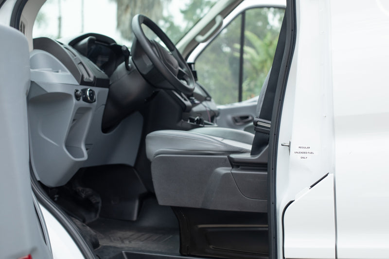 RV rental interior: driver's seat, dashboard, and steering wheel, with 'Regular Unleaded Fuel Only' labeled on the open door. — photo 12