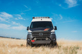 Custom Mercedes Sprinter adventure van, perfect for rv rental, parked in a golden field under blue sky.