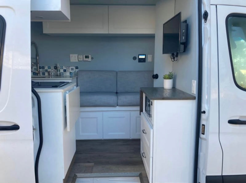  perfect for RV rental adventures.|This custom white camper van with solar panels is perfect for your next RV rental adventure — photo 3