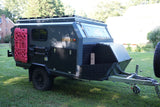 Explore off-road with this rugged camper trailer RV rental, equipped with recovery boards, shovels, and rooftop rack.