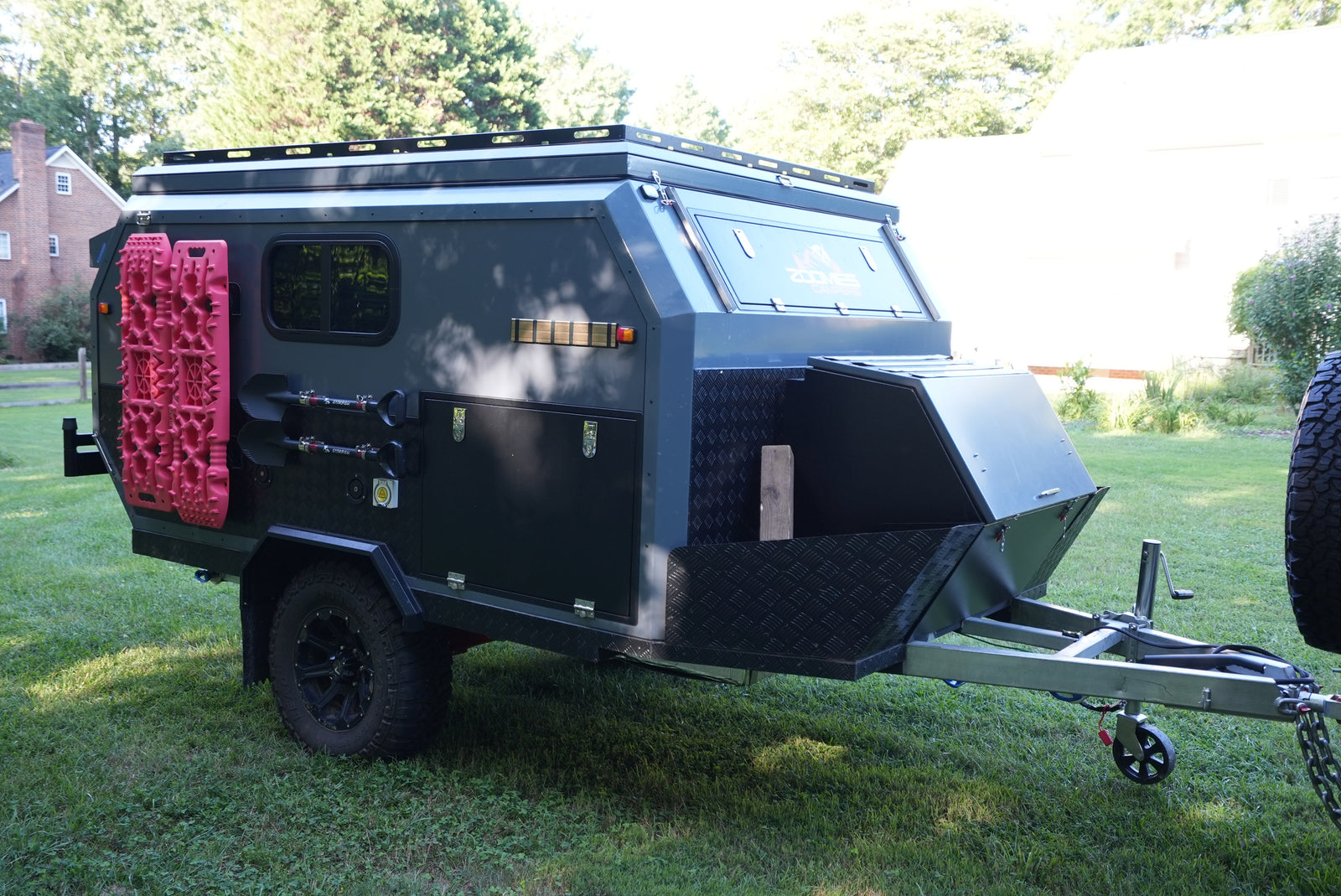 Explore off-road with this rugged camper trailer RV rental, equipped with recovery boards, shovels, and rooftop rack.