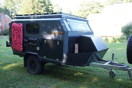 Explore off-road with this rugged camper trailer RV rental, equipped with recovery boards, shovels, and rooftop rack.