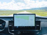 RV rental interior with a large navigation screen showing Ute Pass Rd on a scenic dirt road, 65° temperature.