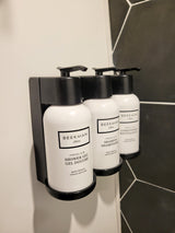 RV rental bathroom: Beekman 1802 shower gel, shampoo, and conditioner in a sleek wall-mounted dispenser.